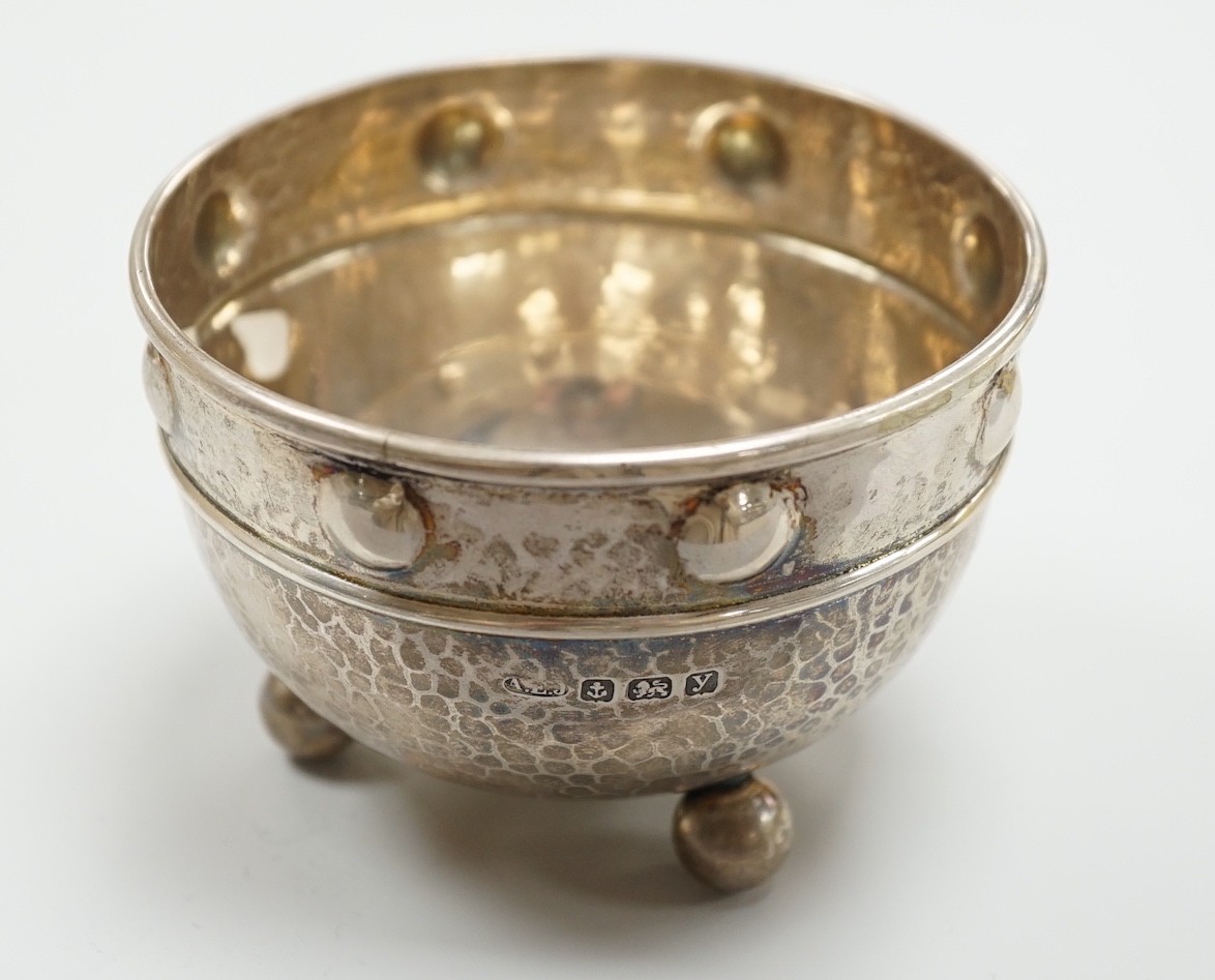 A George V Arts Crafts planished silver bowl, by Albert Edward Jones, Birmingham, 1923, diameter 92mm, on three ball feet, 4oz.